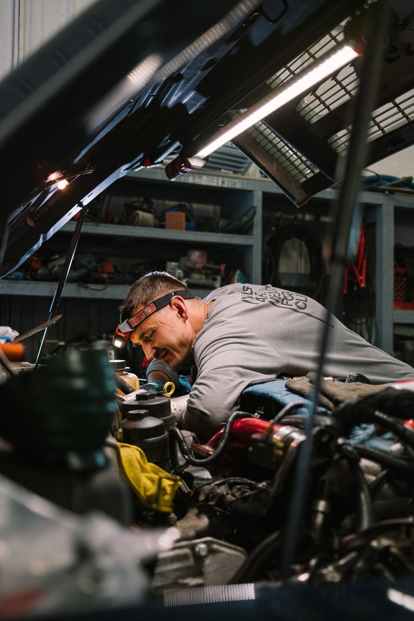 Mechanic working on an engine at Nick's Repair Shop
